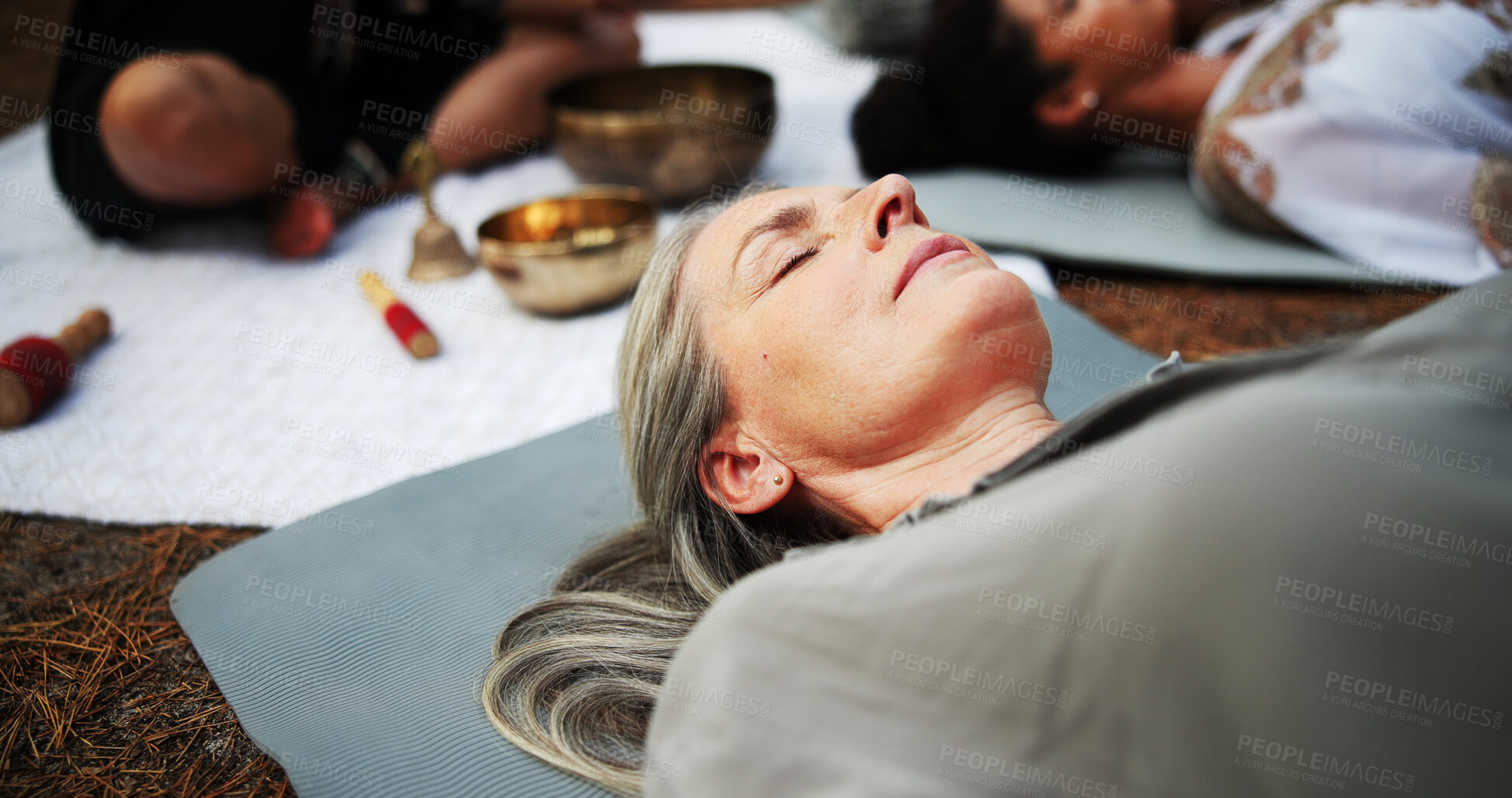 Buy stock photo Woman, sound and meditation with tibetan bowl for spiritual healing or alternative medicine in nature. Female person, sleeping or lying with guru for stress relief, mindfulness or holistic culture