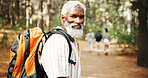 Hiking, nature and portrait of mature man with backpack for exercise, workout and walking for wellness. Fitness, travel and person in forest and woods for trekking, adventure and journey outdoor