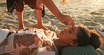 Woman, crystal and chakra balance at beach with shaman, energy and therapy with rest on vacation. People, rocks and holistic care with mineral, mindfulness and peace with zen on ground in summer