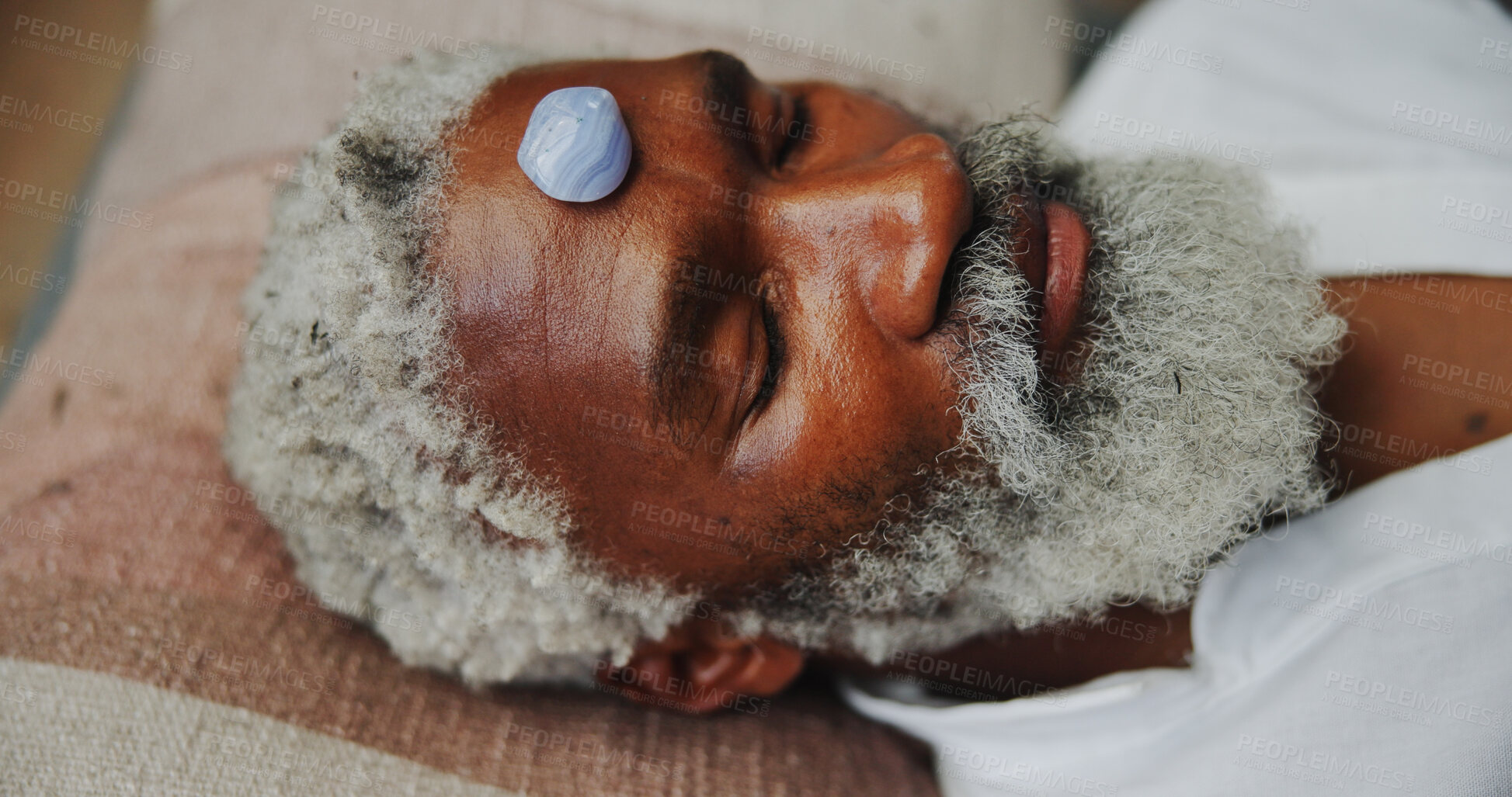 Buy stock photo Crystal, zen and holistic with black man on floor for energy balance, meditation or spirituality. Third eye chakra, peace or healing with senior person for aura cleanse, mind and wellness ceremony