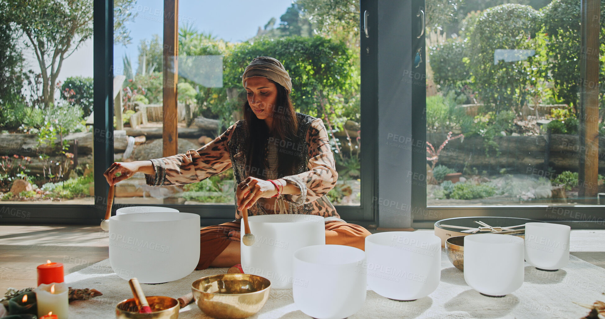 Buy stock photo Woman, sound therapy and healing with naturopath with bowls, ceremony and culture in studio. Female healer, ritual and aromatherapy for Buddhism with herbal remedy or natural vibration with homeopath