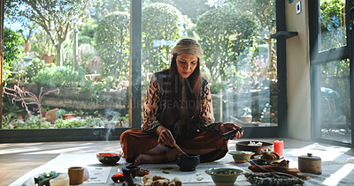 Buy stock photo Woman, natural medicine and meditation with naturopath for Buddhism, ceremony and culture in studio. Female healer, herbs and aromatherapy for spirituality with chakra clean or alternative healing