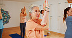 Yoga class, old women and fitness with instructor, spiritual wellness and pilates with energy. Elderly people, trainer or group in health club, stretching or help with exercise, balance or retirement