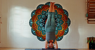 Buy stock photo Balance, upside down or yoga and woman in studio with wall art for fitness or wellness routine. Exercise, headstand or pilates and senior person in class with mandala symbol for holistic health