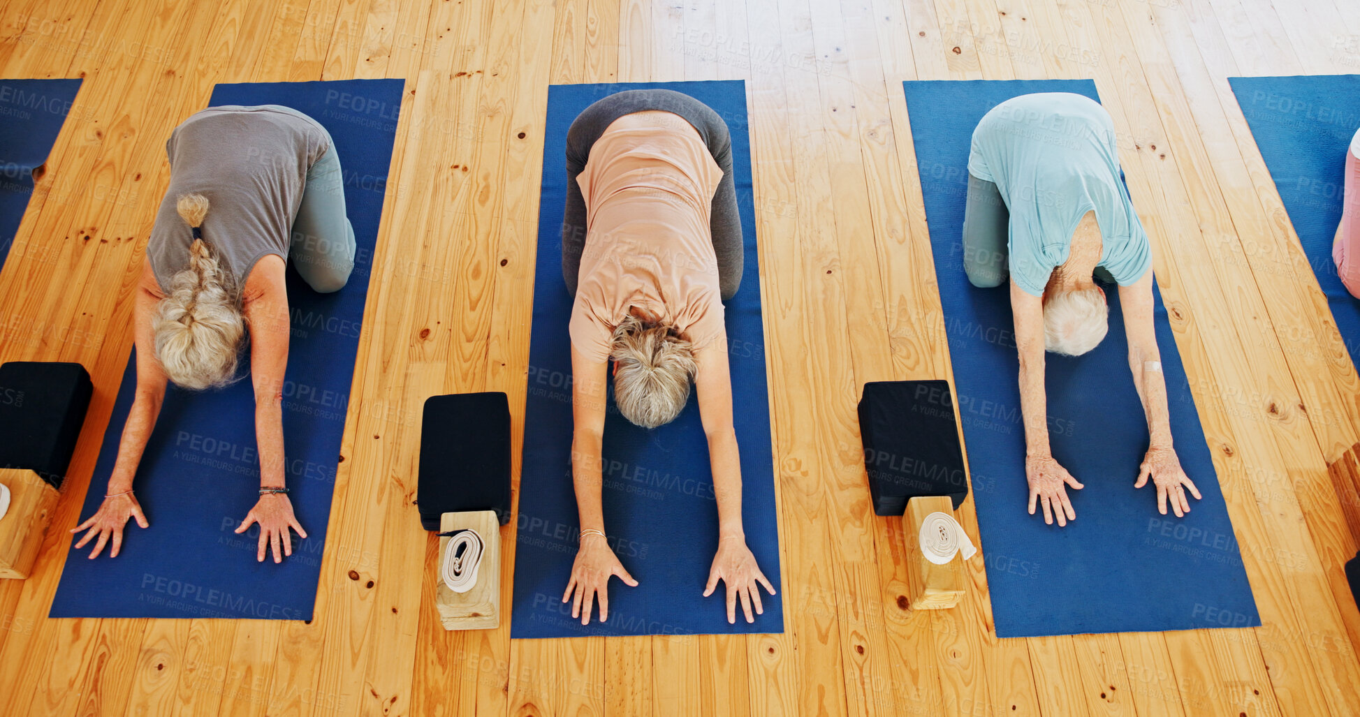 Buy stock photo Above, senior and people stretching in yoga class for fitness, exercise and spiritual wellness. Group, elderly women and child's pose for pilates lesson, community and holistic balance at health club