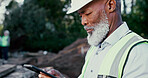 Building, excavation and phone with construction worker black man on site for development or planning. Architecture, app and communication with mature developer outdoor for industrial engineering