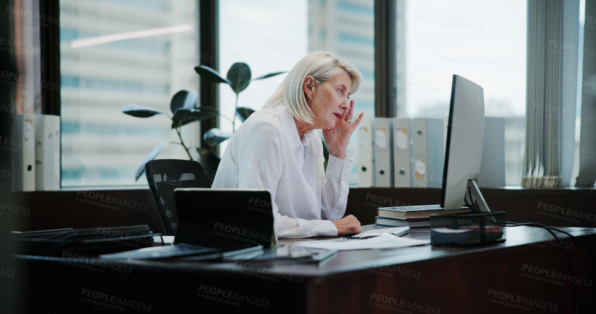 Buy stock photo Mature woman, headache and stress at office by computer, tired and fatigue with deadline for admin. Person, migraine and frustrated with pain, burnout or brain fog with paperwork by PC in company