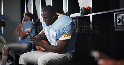 Buy stock photo Athlete, football and man with phone in locker room for text message, mobile chat response and match break. Sports, player and relax with smartphone for social media scroll, online news or connection
