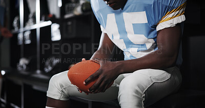 Buy stock photo Hands, football and player with ball in locker room for preparation, sports match and waiting on game. Male athlete, getting ready and half time of competition, fitness challenge and tournament event