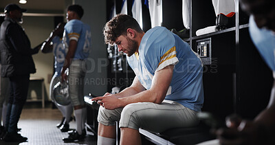 Buy stock photo Football, sports and man with phone in locker room for text message, check notifications and match break. Player, athlete and relax with smartphone for social media scroll, online news or mobile chat