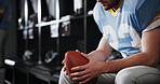 Hands, man and football player with ball in locker room for preparation, sports match and game plan. Male athlete, getting ready and half time for competition, fitness challenge and tournament event