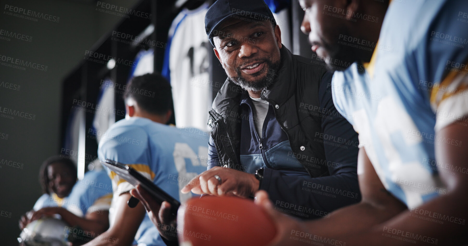 Buy stock photo Black men, coach and football captain on tablet in locker room for game plan, strategy and layout. African mentor, athlete and sports trainer on technology for brainstorming match and play routine