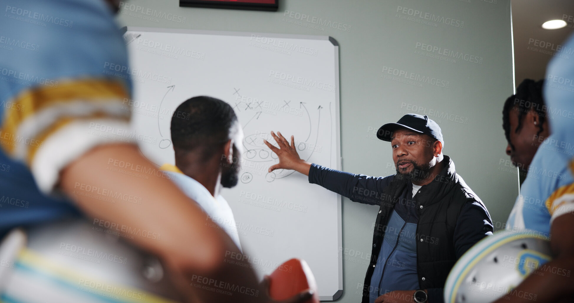 Buy stock photo Board, teamwork and football with coach and men in locker room for game plan, sports strategy or defense formation. Touchdown tactics, match feedback and discussion with people and training advice