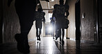 Light, football and walking and team in corridor for sports competition, stadium match and game. Fitness, pro league player and athlete with people in tunnel for training, tournament and contest