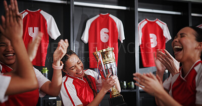Buy stock photo Happy women, soccer team and celebration with trophy for winning, victory or tournament in locker room. Excited, female people or sports players with smile for competition, success or award together