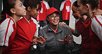 Women, coach and discussion with soccer team for motivation or collaboration in locker room. Female people, coordinator or talking with group or sport players in huddle for idea, game plan or match