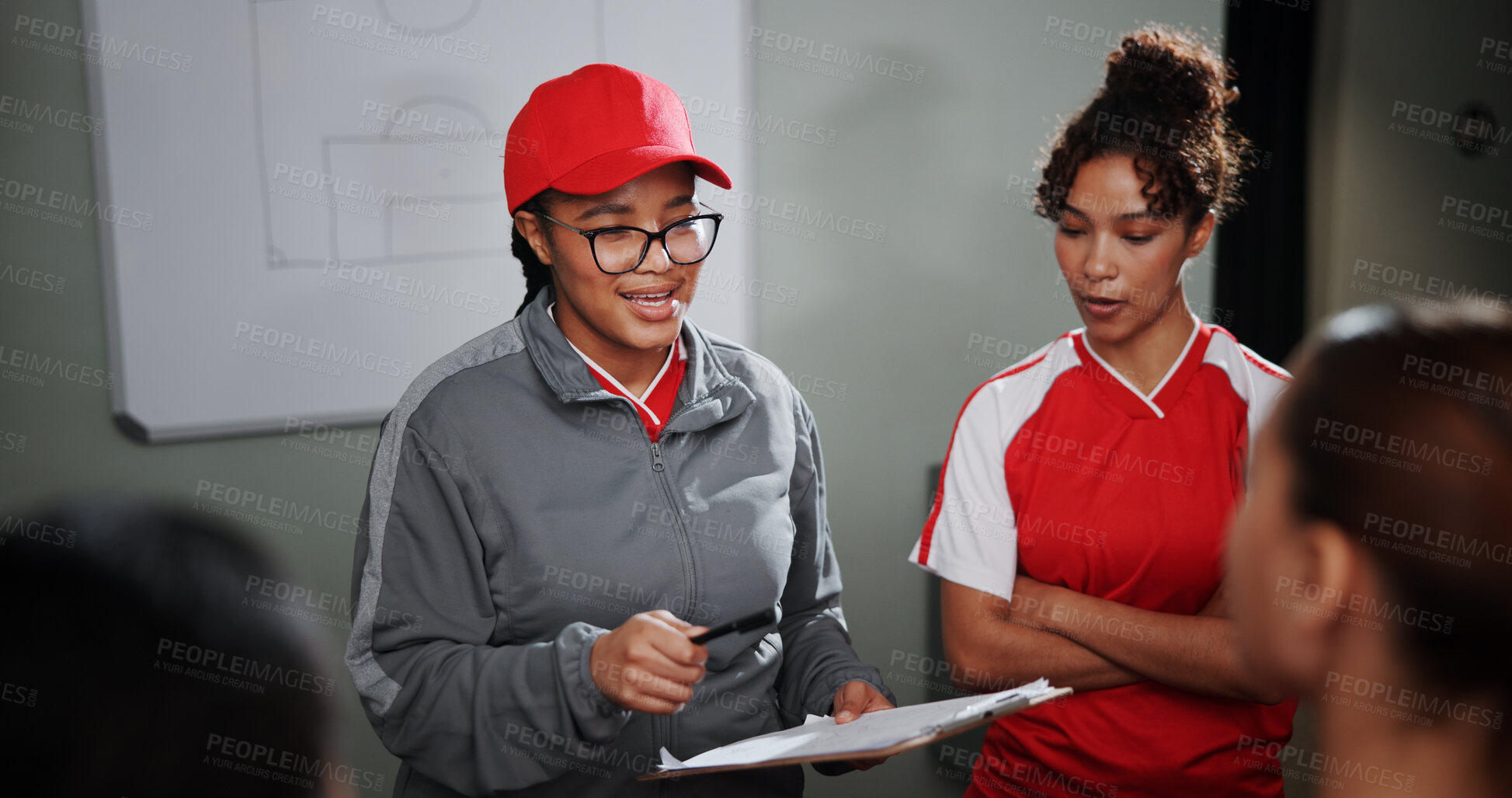 Buy stock photo Women, coach and meeting with soccer players for game plan, strategy or discussion together. Female people, trainer or coordinator talking to group or team with clipboard for sport match or formation