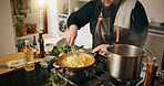 Cooking, pasta and man in kitchen in home for health, wellness or diet dinner with recipe. Pot, chef and male person with food for gourmet supper, meal or cuisine with ingredients in apartment.