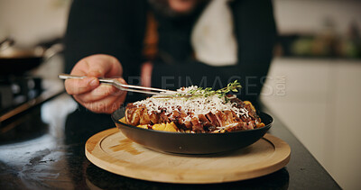 Buy stock photo Person, hands and chef with food, cuisine or serving for hospitality, meal or dinner in kitchen at home. Closeup, culinary artist or skill with ingredient for cooking or fine dining recipe at house