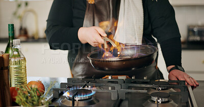 Buy stock photo Cooking, flame and man in kitchen, hands and frying pan with food, wellness and ingredients. Closeup, person and chef with utensils, fire or meal prep with nutrition, culinary skills or flambe expert