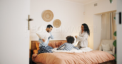 Buy stock photo Happy family, bed and playing with pillow fight for fun bonding, game or holiday together at home. Dad, mom and playful child enjoying weekend or bedroom war with soft cushion in pajamas at house