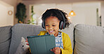 Tablet, headphones and happy child in home for music, online learning and play game for education. Girl, audio and kid with tech in living room for internet app, streaming cartoon and watch video