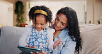 Mother, child and tablet in home for learning, storytelling or reading ebook together. Girl, kid and parent with technology on sofa for education, teaching or play game on internet with happy family