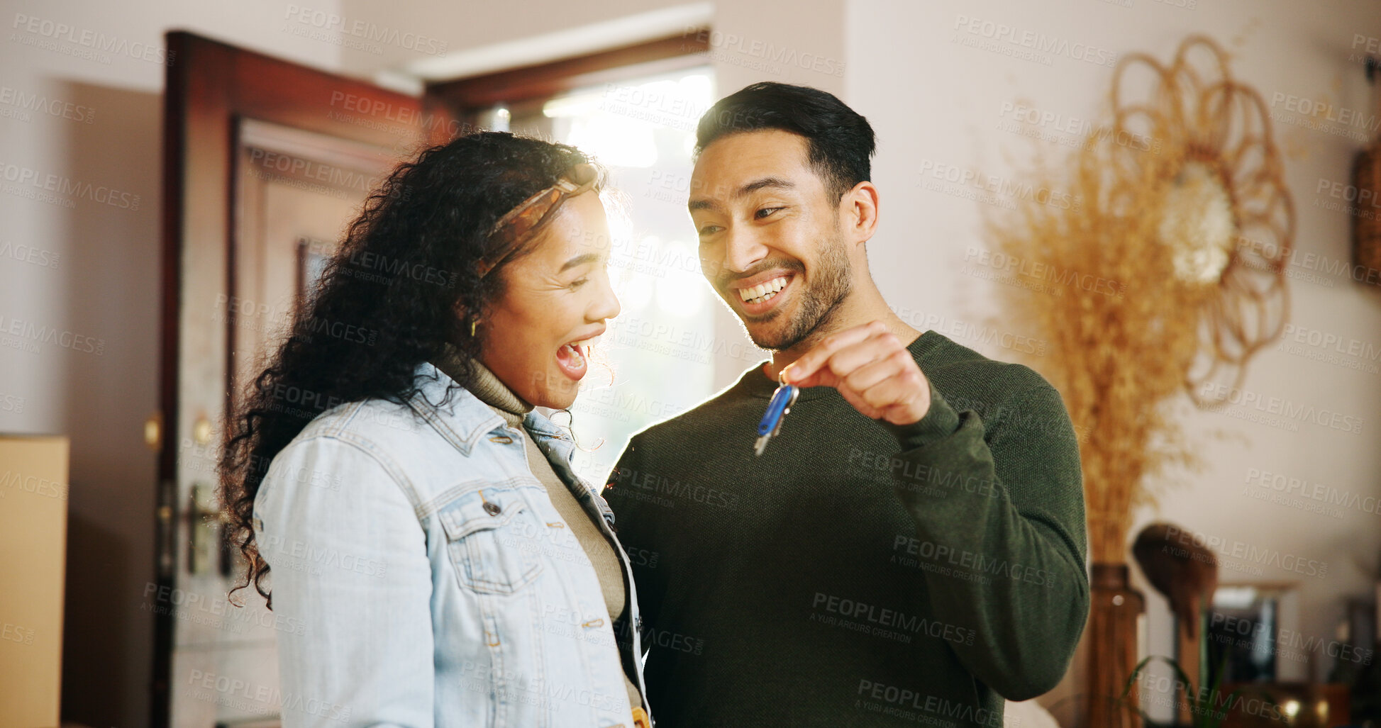 Buy stock photo Couple, keys and moving in with new home, relocation and finance investment together. Excited man, woman and smile with property, real estate or house for mortgage loan, renovation and success