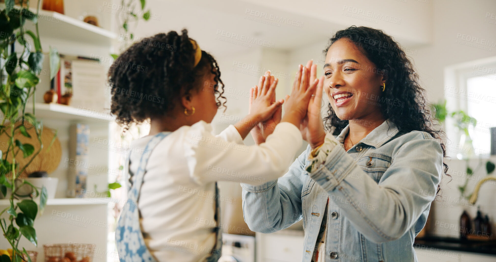 Buy stock photo High five, game and hands with mother, girl and kitchen of home together for bonding. Laughing, love and smile with single parent, woman and daughter playing in apartment for motor skills development