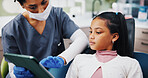 Clinic, child and dentist with tablet for consultation, dental education and information in healthcare. Discussion, girl patient and orthodontist with digital for teeth procedure, checkup and results