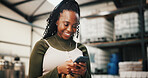 Business, smile and black woman in factory, smartphone and social media with online order. African person, employee and manufacturing with cellphone, email for inventory and message to contact or app