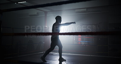 Buy stock photo Boxing, punch and silhouette with man in ring for sparring practice, training and fitness. Mma club, wrestling challenge and martial arts fighter with person in gym for performance and self defense