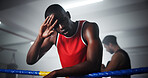 Man, boxer and headache in ring for training, fitness and fatigue with burnout, rest and low angle at gym. Person, athlete or fighter with pain, tired or concussion for combat sports at exercise club