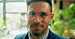 Portrait, glasses and business man in office with job as green consultant with ambition, pride and smile. Face, professional employee and confident corporate worker or sustainability advisor in UAE