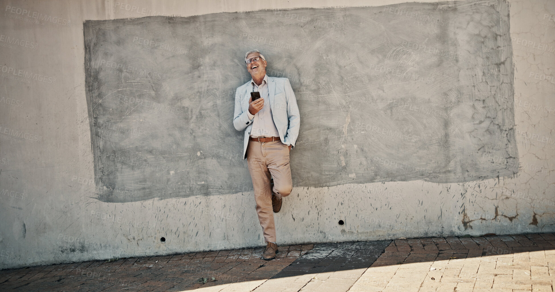 Buy stock photo Business, funny and man with smartphone, wall and smile with connection, meme and texting. Mature person, outdoor and employee in city, cellphone and digital app for online comedy, humor and joke