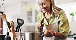 Scent, cooking and mature woman in kitchen in home with smelling dinner, meal or dish. Happy, pot and female person with satisfaction for aroma of supper with health, wellness and nutrition in house.