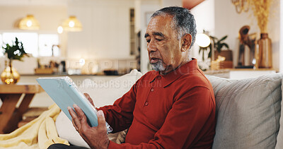 Buy stock photo Senior man, tablet and thinking with living room, sofa and reading online news blog post. Relax, digital technology and mature person with app, internet scroll and social media at home for retirement