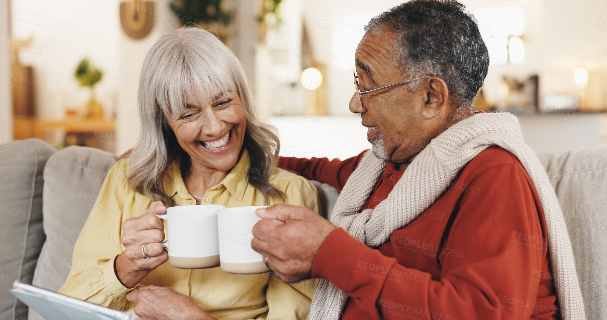 Buy stock photo Senior couple, toast and coffee on sofa with smile, tablet and relax with movie, love and connection in home. Elderly people, man and woman with celebration, cheers and app on touchscreen in lounge
