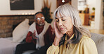 Couple, old woman and headache with fight on sofa for marriage dispute, toxic relationship and disagreement. Conflict, senior people and stress in home for divorce argument, separation and cheating