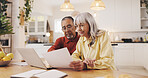 Senior couple, documents and finance in home for results, laptop or smile with review for pension. Interracial relationship, man and woman for budget, happy or profit for retirement income in kitchen