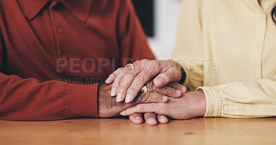 Buy stock photo Home, table and old couple with holding hands for support, empathy and comfort to partner with grief. Closeup, senior people and love with sympathy for loss, compassion and kindness with commitment