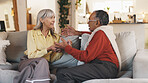 Senior couple, talk and relax on sofa in home with smile, listening and discussion in living room. Elderly people, man and woman with chat, conversation and bonding with love in retirement at house