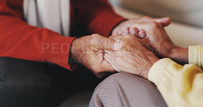 Buy stock photo Holding hands, senior couple and comfort in home with care, love and prayer for faith in retirement. People, connection and support with bonding, trust and loyalty with relationship at apartment