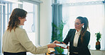 Business, women and resume with interview in office for recruitment process, job portfolio and internal vacancy. Hiring, HR manager and candidate with CV for performance review and company promotion