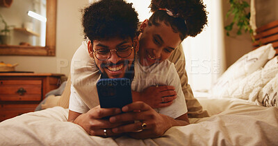 Buy stock photo Bed, love and happy couple hug with smartphone for social media, reading comments and gossip blog. House, relationship or people with smile or mobile for application, online post or streaming website