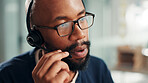 Black man, consultant and talking with headset at call center for online advice or customer service. Male person, agent or employee speaking with mic for virtual assistance, help or communication