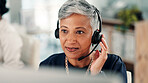 Mature woman, consultant and listening with headset on computer for online advice or customer service. Female person, agent or employee with mic or technology for virtual assistance at call center