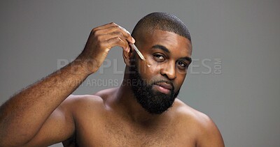 Buy stock photo Serum, beauty and portrait of black man in studio for salon, grooming and dermatology. Cosmetics, glow and self care with person and oil dropper on gray background for hydration, skincare and shine