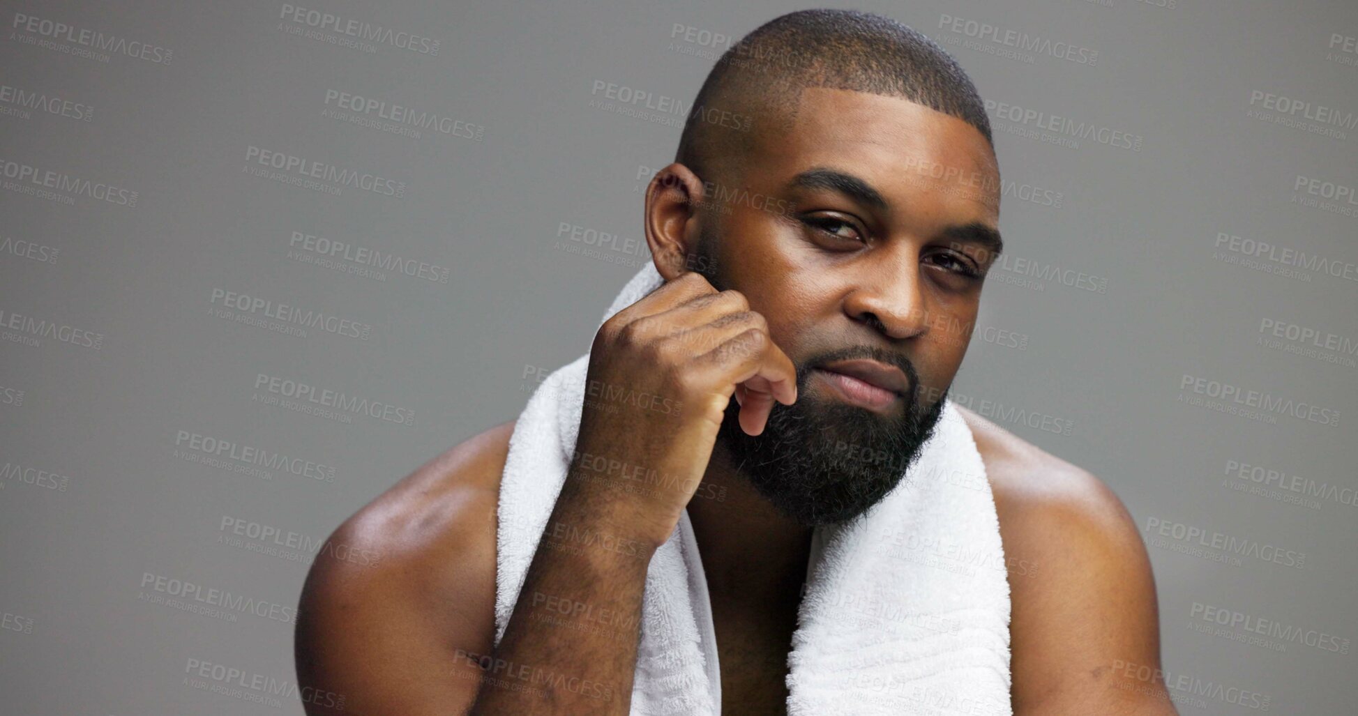 Buy stock photo Shower, beauty and portrait of black man in studio for skincare, grooming and dermatology. Cosmetics, glow and self care with person and towel on gray background for hydration, hygiene and shine