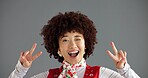 Portrait, wink and happy woman with peace sign in studio for retro fashion on gray background. Excited, hand gesture or person with v symbol for victory, social media emoji or influencer with success